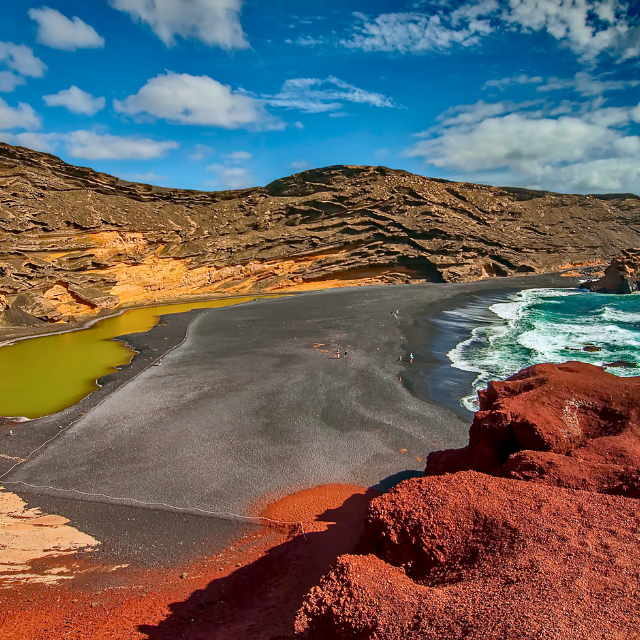 Überblick von einer Klippe auf El Golfo mit der grünen Lagune, schwarzen Sand und rotem Felsen